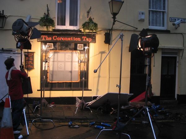 Film lights and a crew set up outside the front of the Cori Tap for a shoot